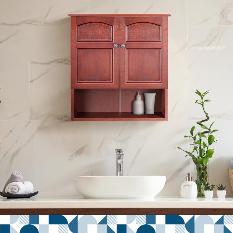 A cherry wood toned wall cabinet with two doors and a bottom shelf hangs on a marble wall over a modern white sink.