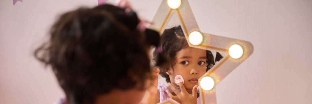 A blue, princess themed vanity sits in a winter-themed blue bedroom