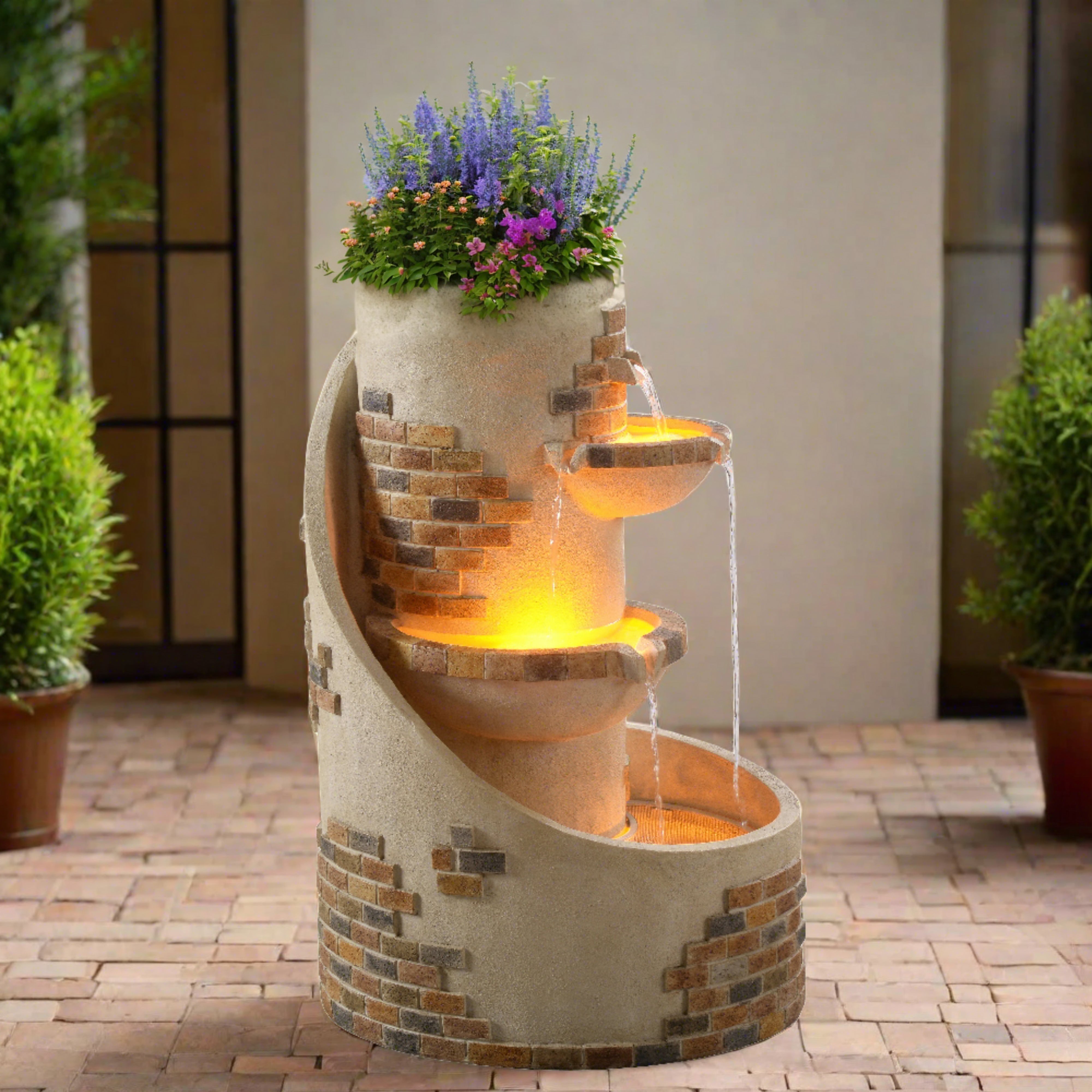 the exposed brick fountain with planter sits in a lush garden at dusk