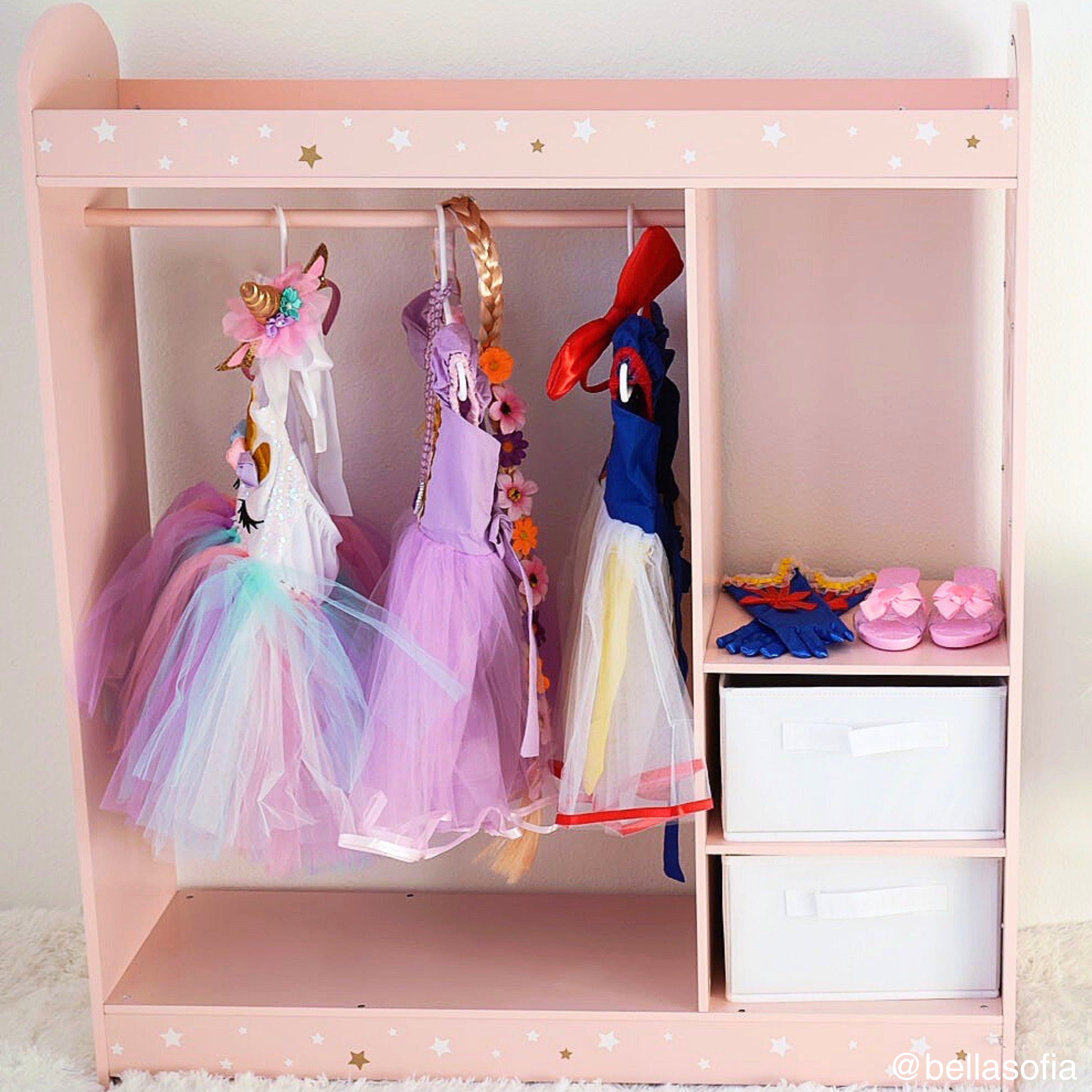 a pink dressing rack sized for little ones features a star print, plus organization