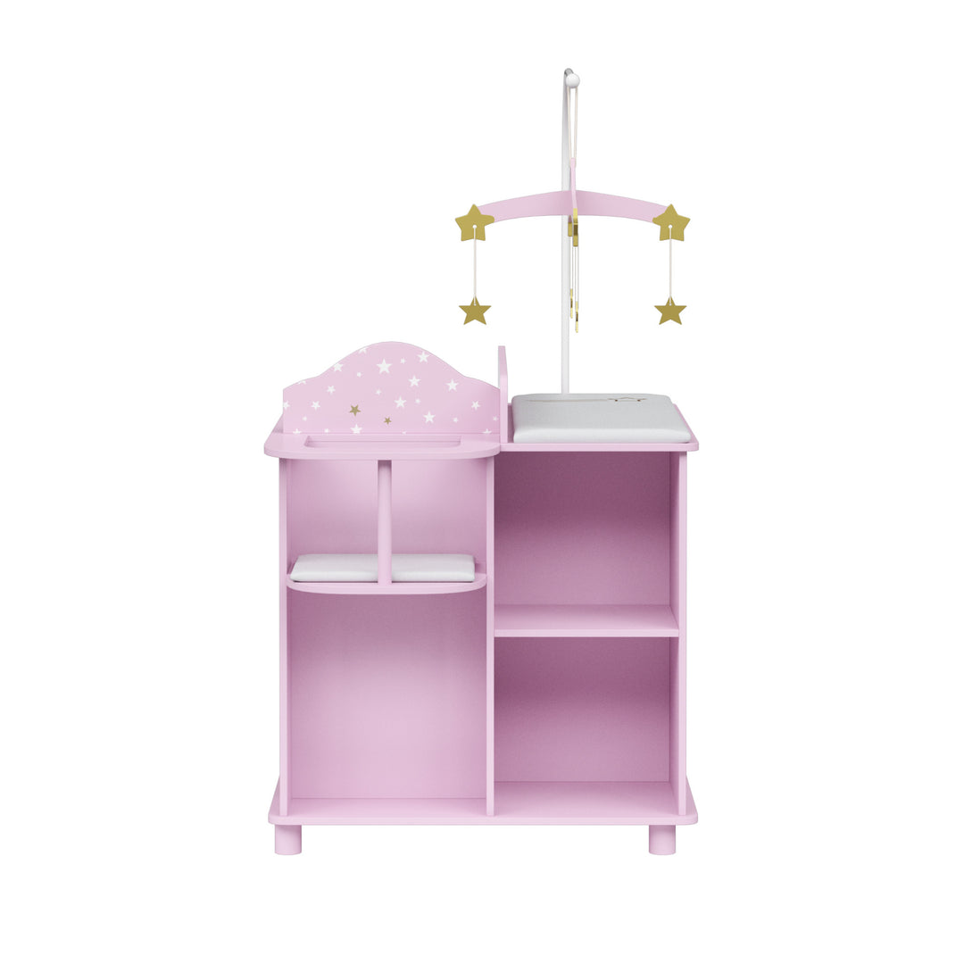 Pink doll toy changing station with a decorative star mobile, a changing area, and shelves for storage.