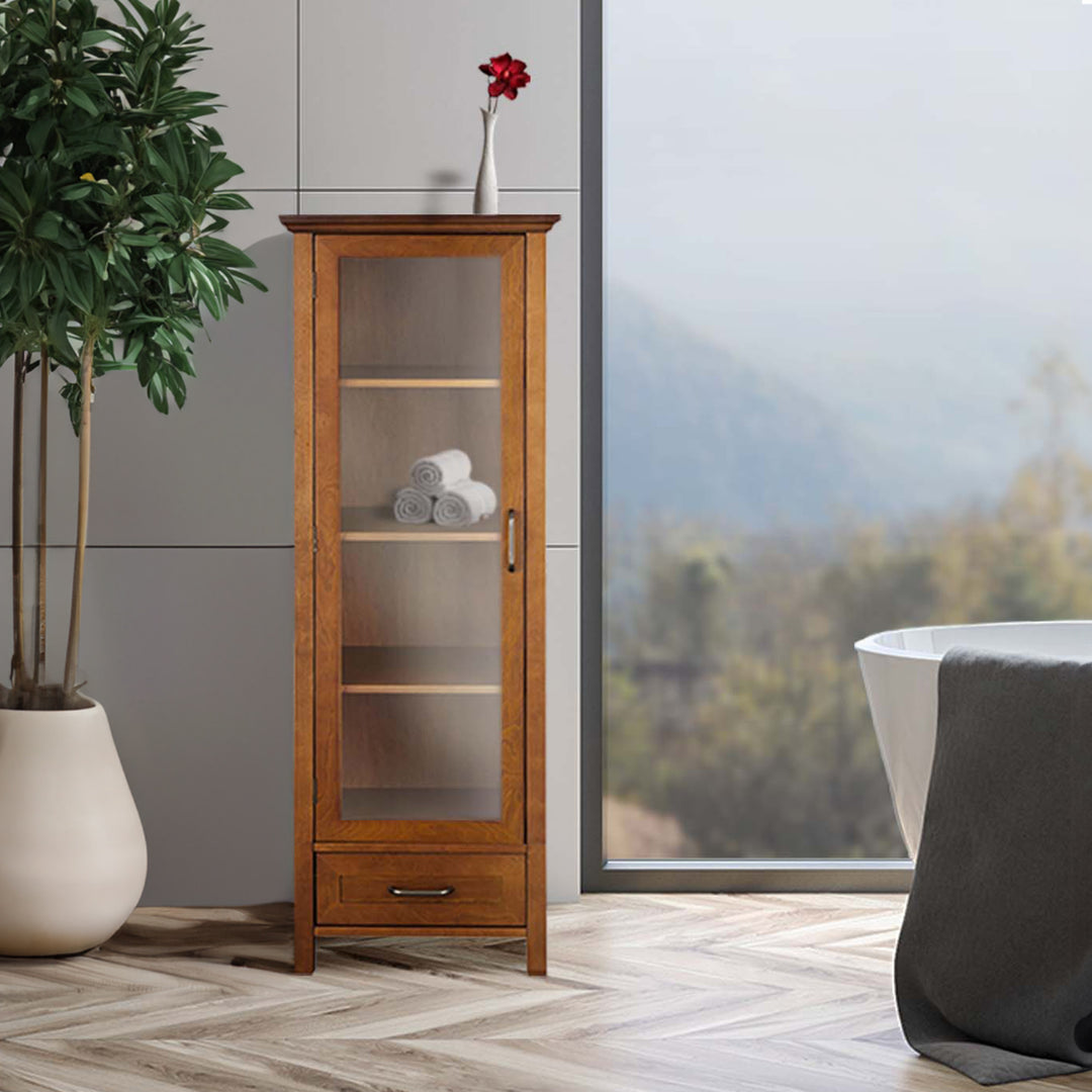 Tall cabinet with a glass door, four shelves and a bottom storage drawer next to a big window