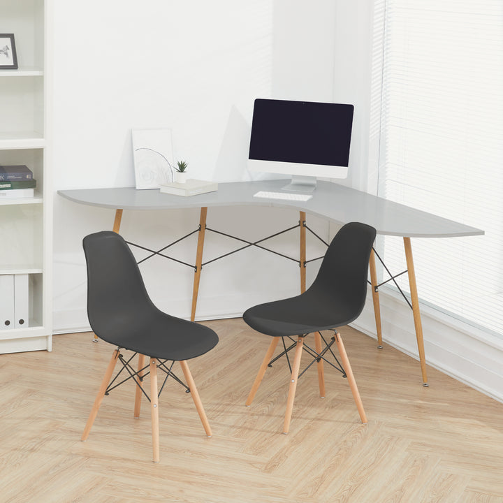 A pair of black chairs sat next to an L-shaped desk