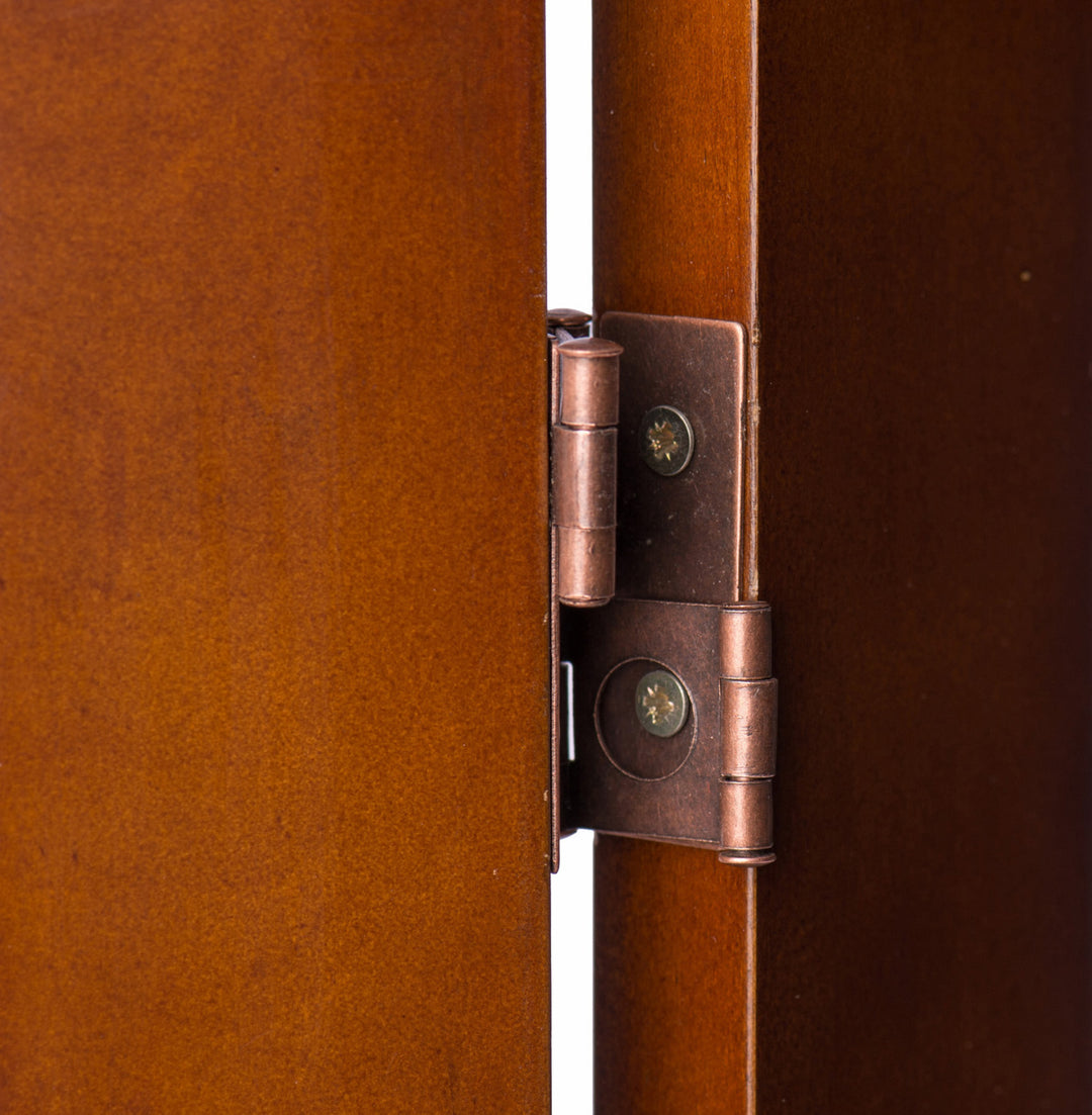 close-up of copper-colorred hinges between two panels