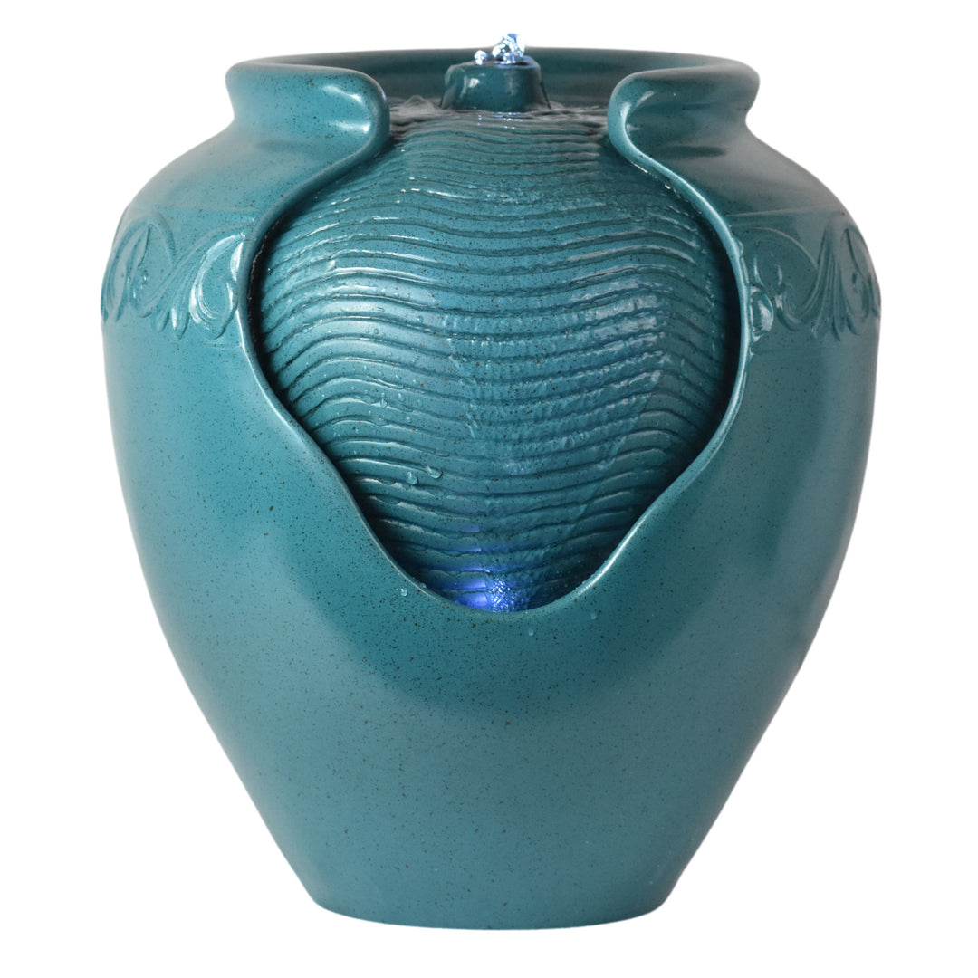 A teal vase shaped water fountain with exposed surface