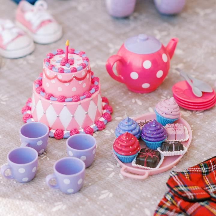 A tea set for 18" dolls with a birthday cake with tea cups and cupcakes