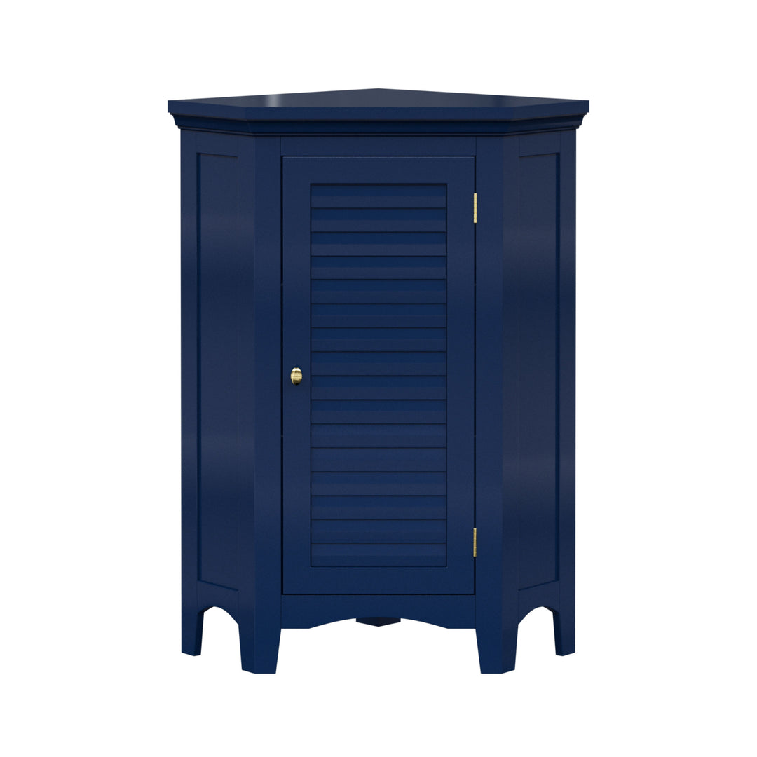 A navy blue corner floor cabinet with gold knobs and two faux louvered doors.