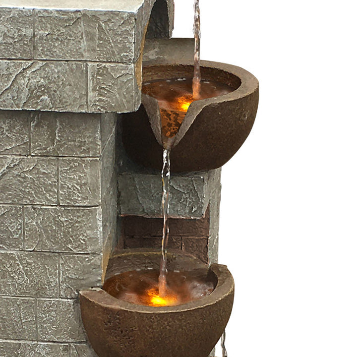 Close-up of two cascading pots with lights underneath the water