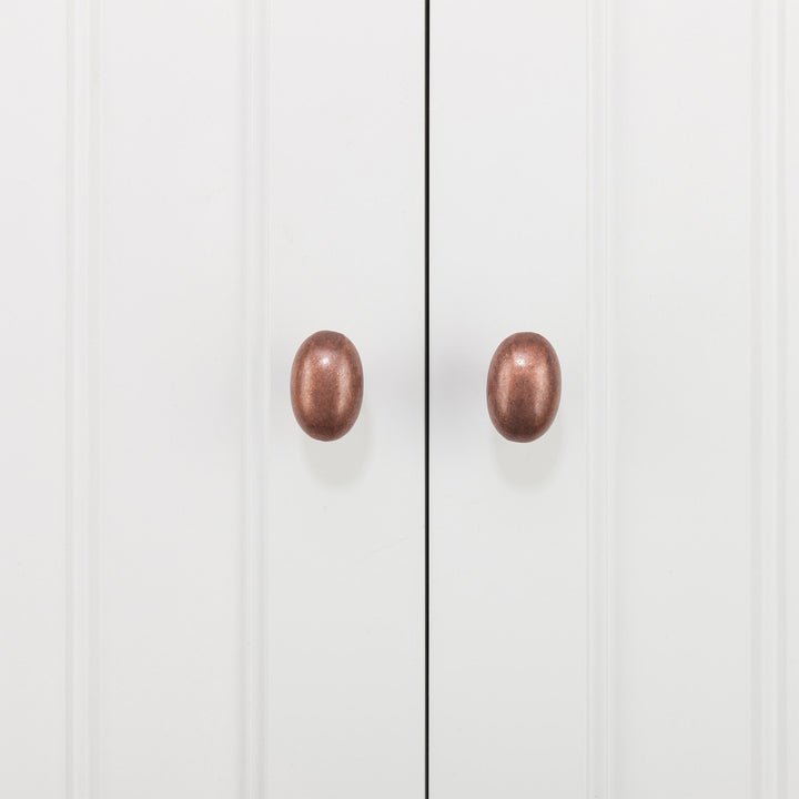 Closeup of a copper colored egg-shaped door pulls