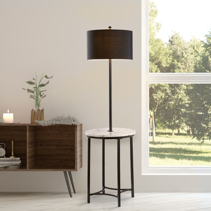 A floor lamp with a faux white marble table top and black lamp shade