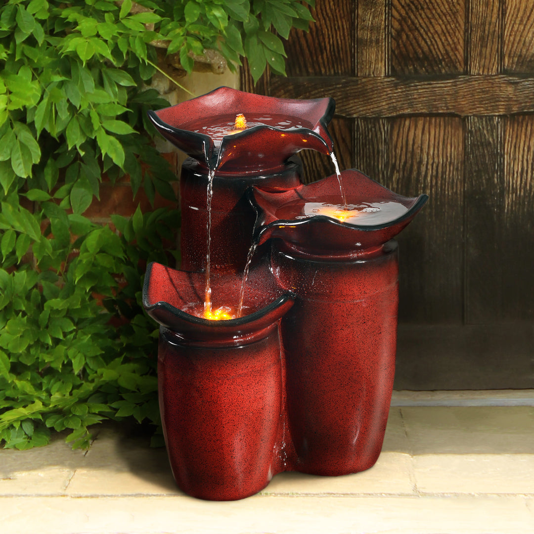 A red water fountain of three staggered vases
