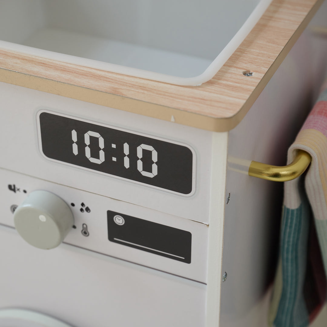 Close-up of toy sink area with digital clock sticker display, control knob, part of a play kitchen.