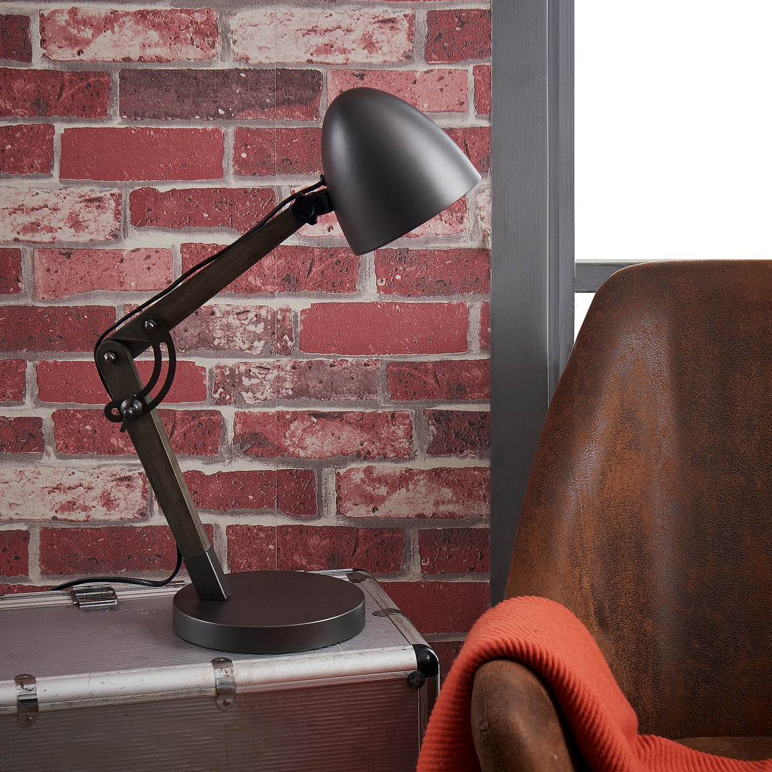Black gooseneck desk lamp next to a brown leather chair