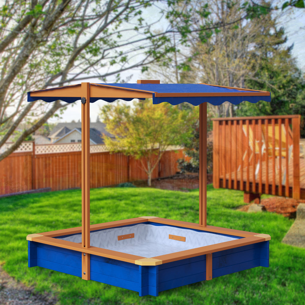 A blue and wood-toned sandbox with a blue awning in a backyard