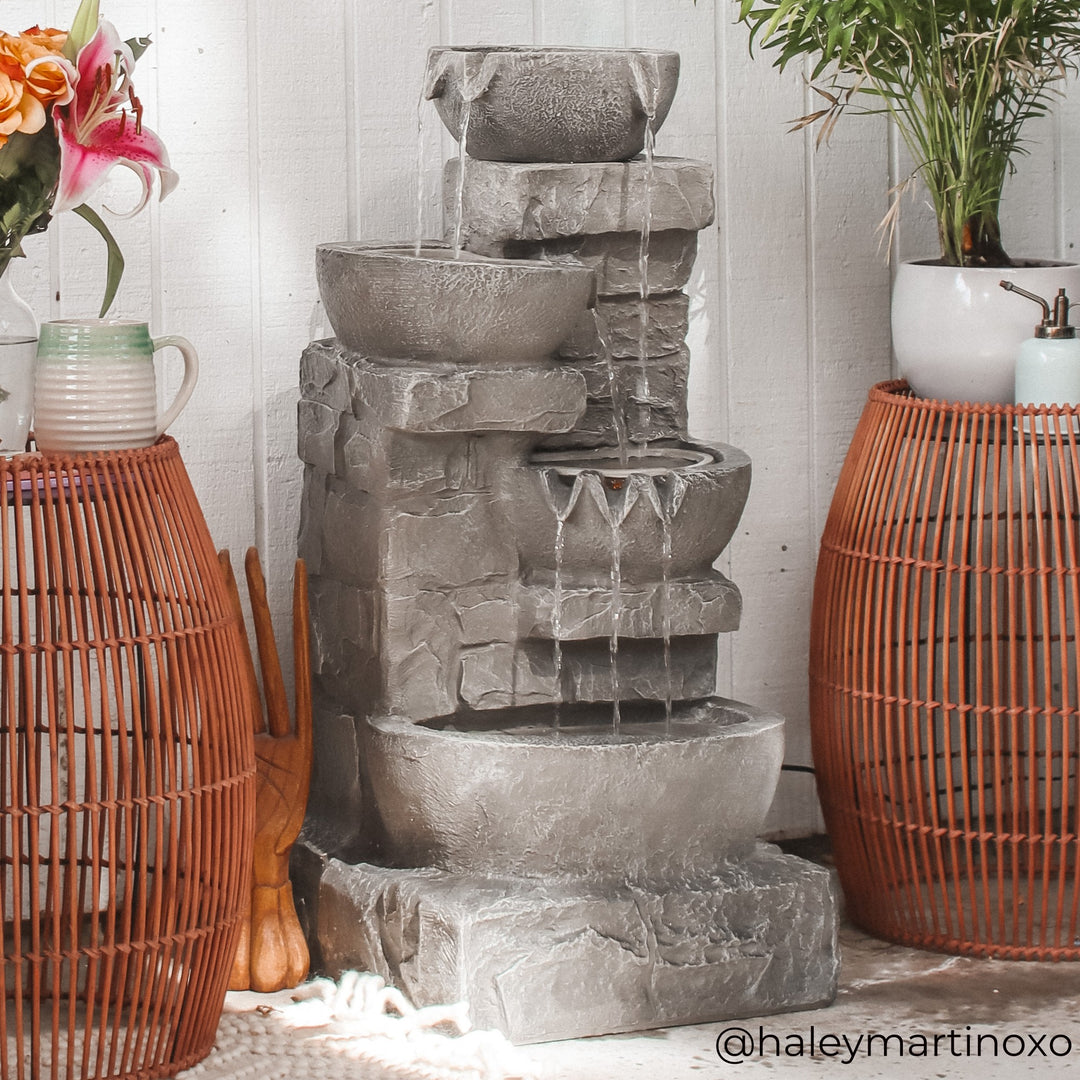 4-tier faux gray stone water fountain in a tropical setting