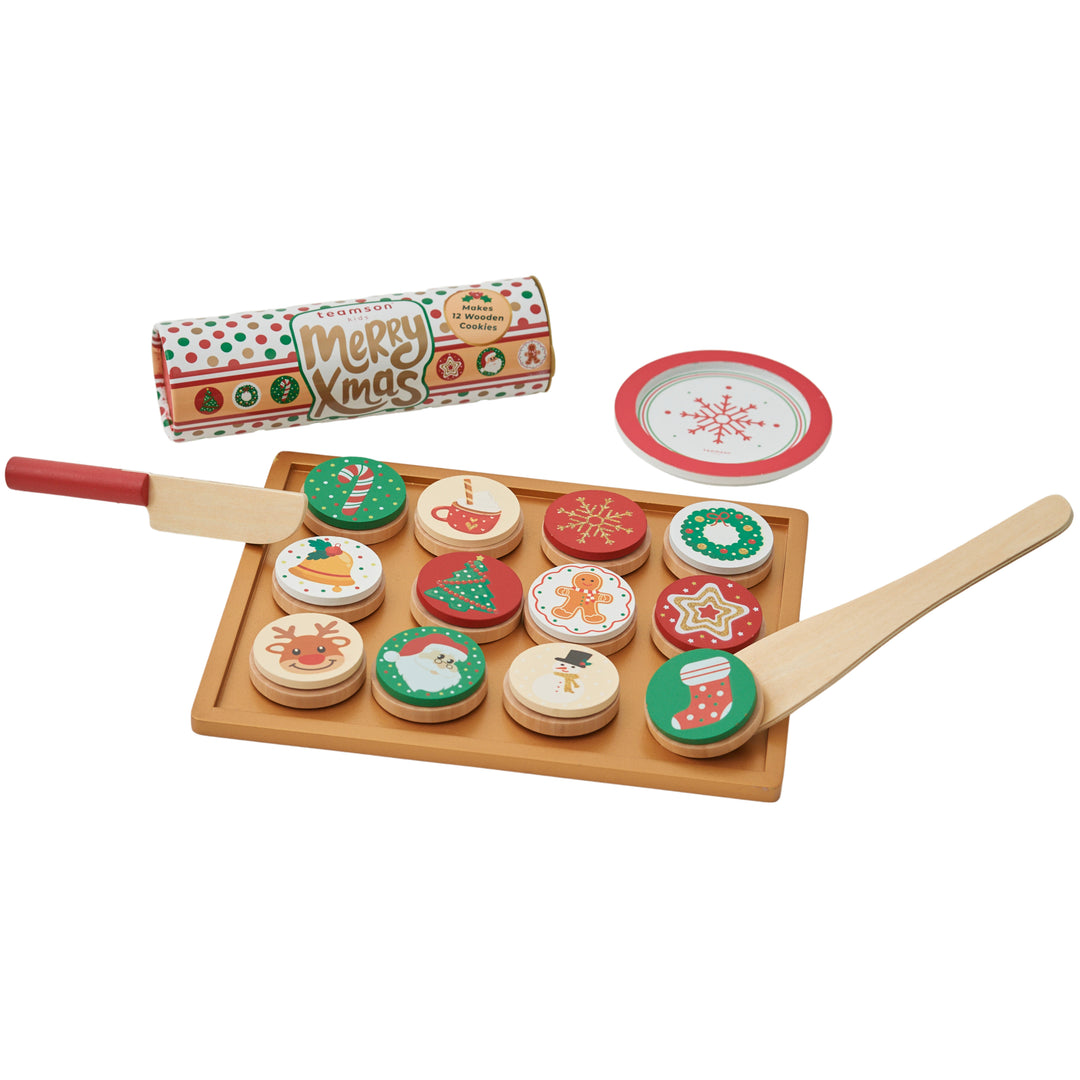 A tray with pretend christmas cookies, a spatula, a knife, a plate and a roll of dough