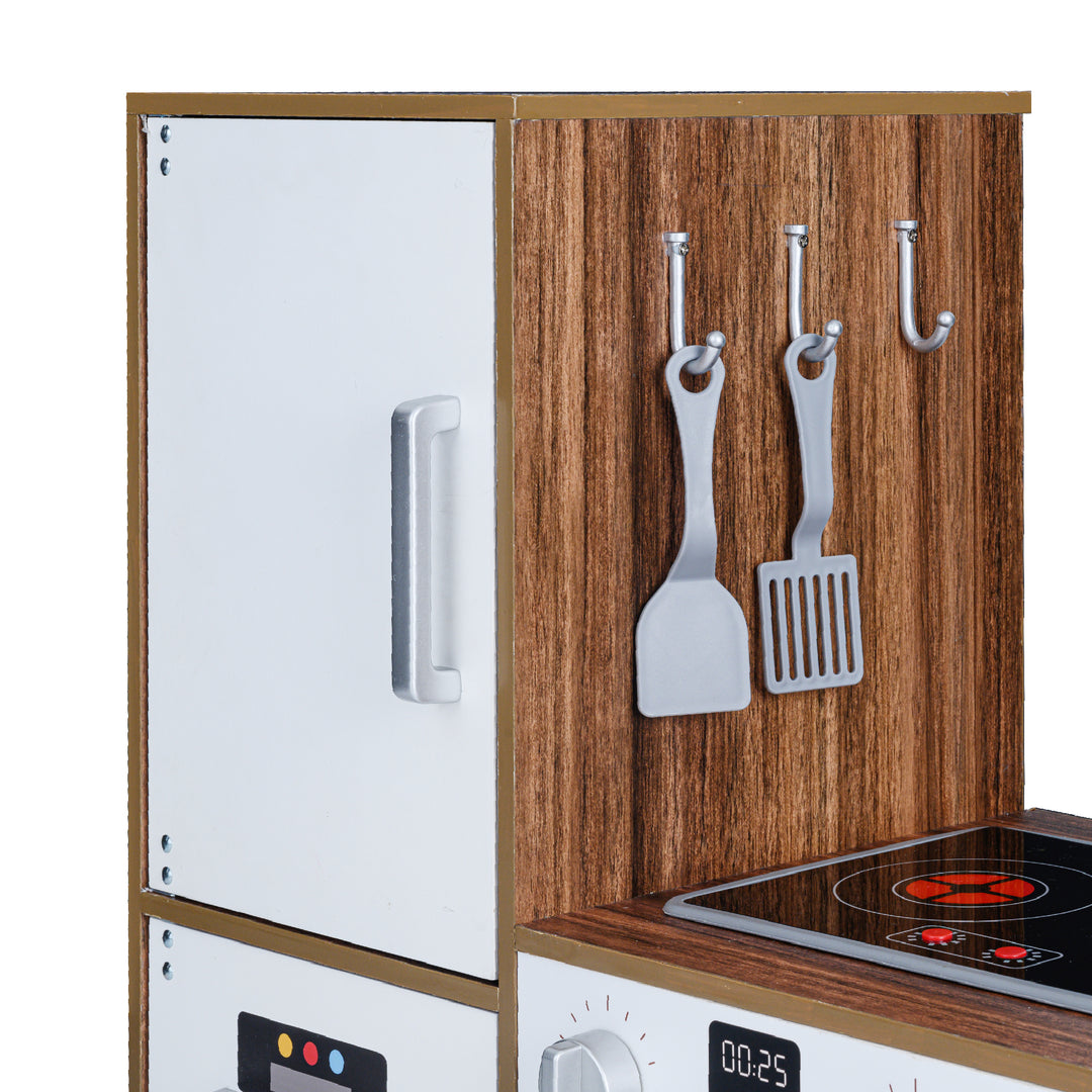 A Teamson Kids Little Chef Palm Springs Classic Kids Play Kitchen with Accessories, Natural/White with hanging utensils next to a white refrigerator and a stove with interactive features.
