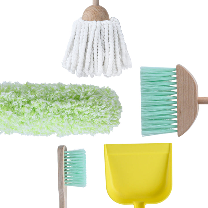 Close-up of items from a play cleaning kit: a feather duster, yarn mop, broom, dust pan, and brush