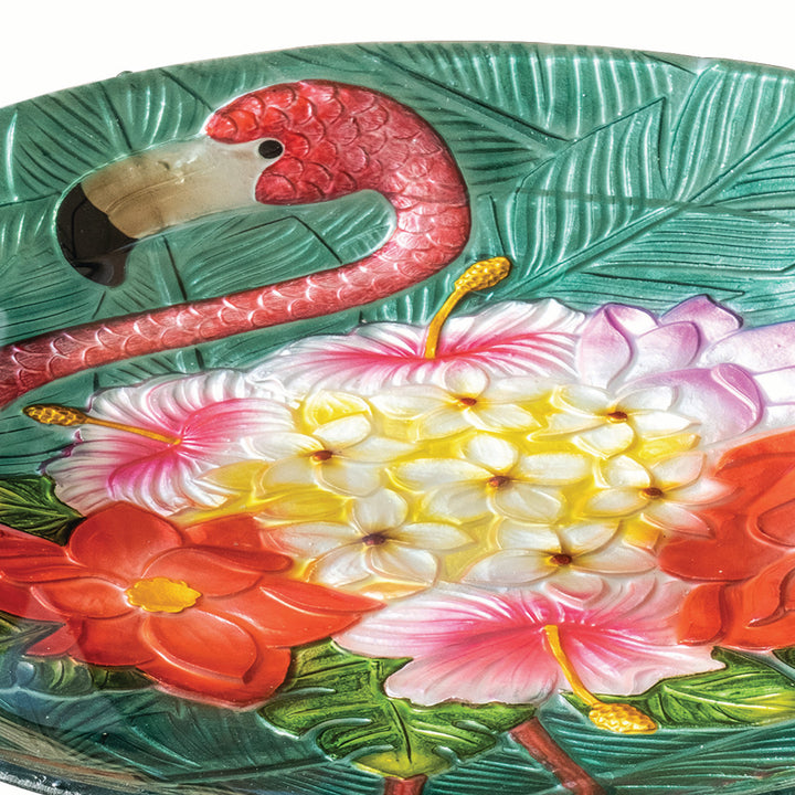 Closed up of the flamingo, palm leaves, and tropical flowers in colorful detail.