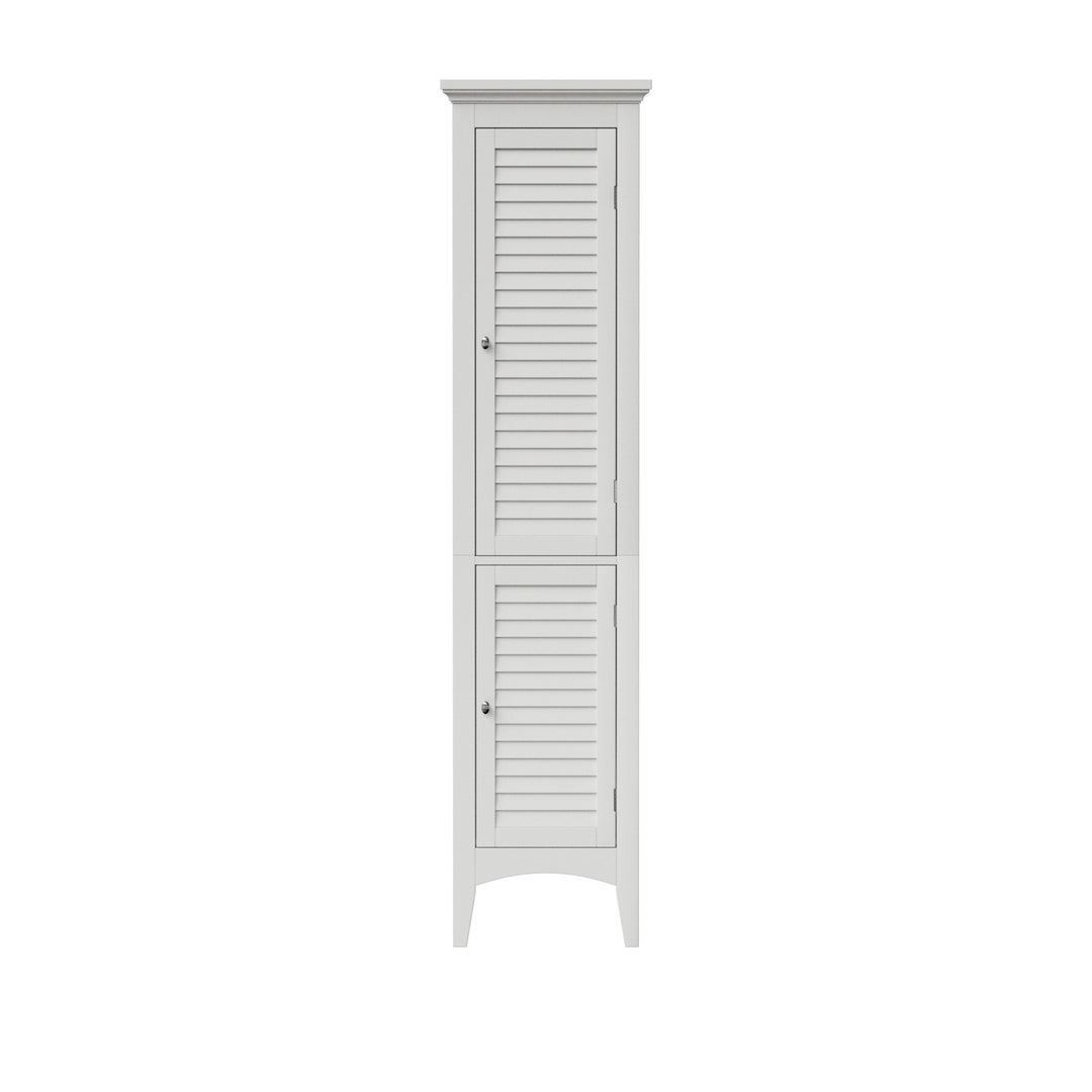 Tall white linen cabinet with two faux louvered doors