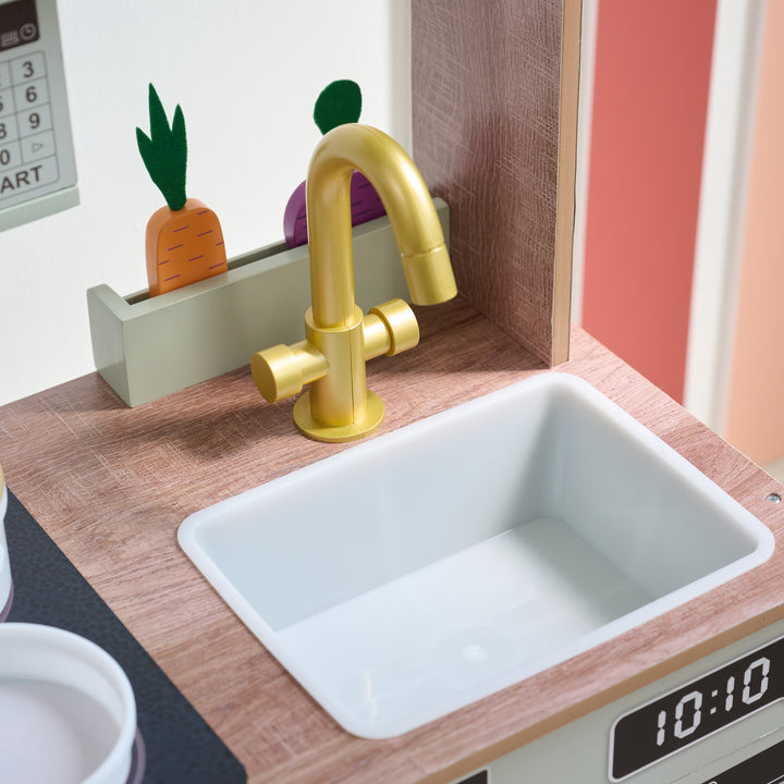 Close-up of toy kitchen sink with gold faucet, wooden countertop, and wooden vegetable mini garden behind the sink.