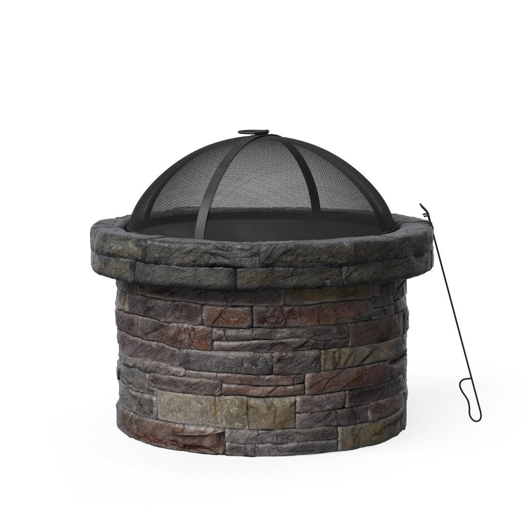 A round faux brick wood burning fire pit with a spark screen and poker