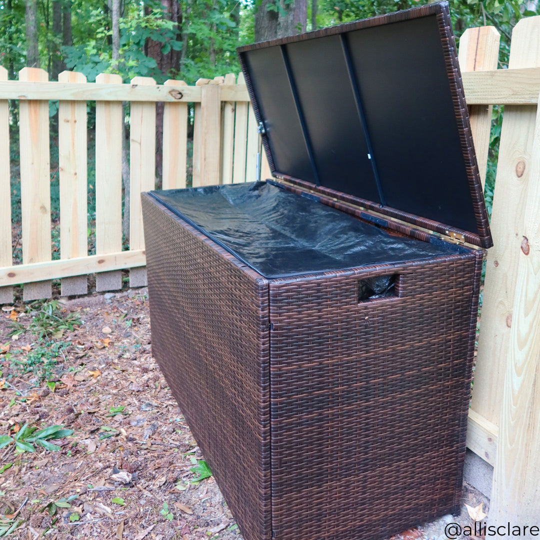 Brown PE rattan storage container with inner lining zipped closed against a fence