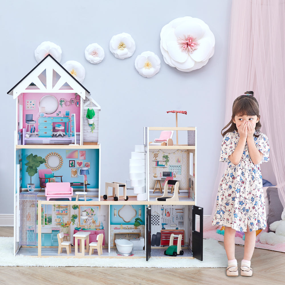 A little girl standing next to the dollhouse with  floral dress.