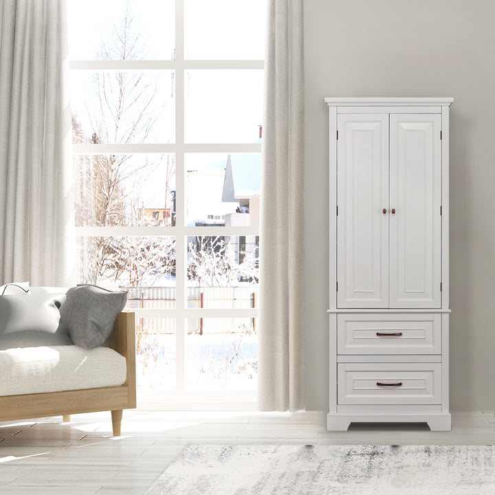 Tall white cabinet with double doors and two drawers on the bottom next to a window
