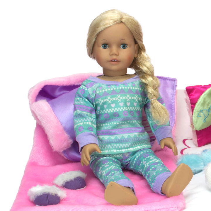 A blonde 18" doll in lavender and aqua pajamas on a pink furry sleeping bag