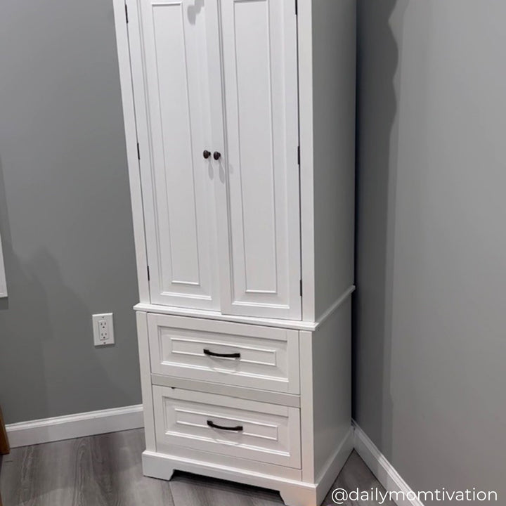 Tall white cabinet with double doors and two drawers on the bottom in the corner of a gray room