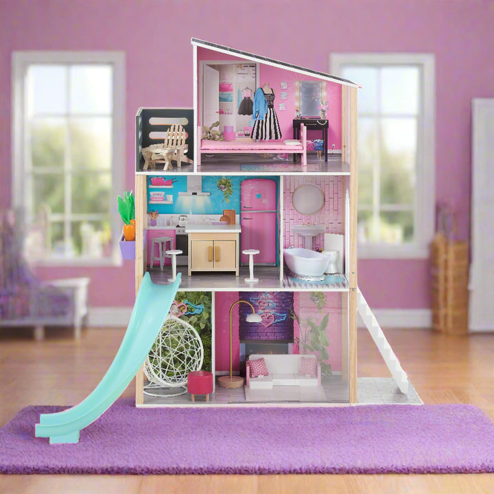 a modern, brightly colored dollhouse with a slide, fully furnished is displayed in a girly play room