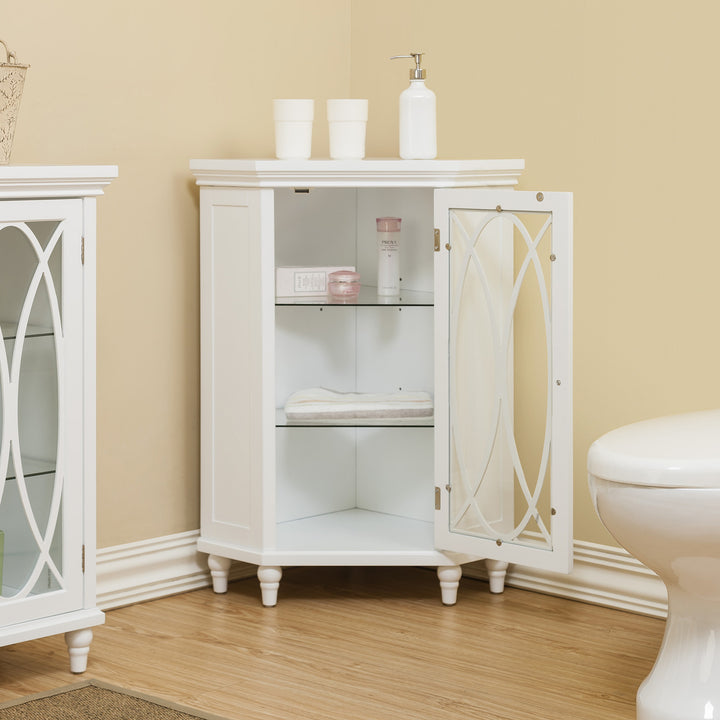 A white corner floor cabinet in a yellow bathroom with items on the shelves inside
