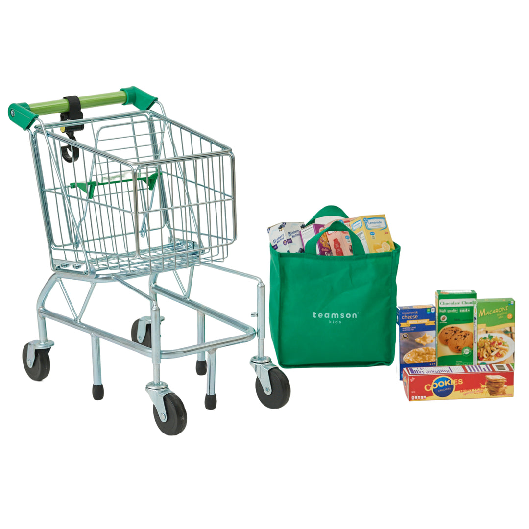 A kids grocery cart, grocery bag and boxes of pretend food