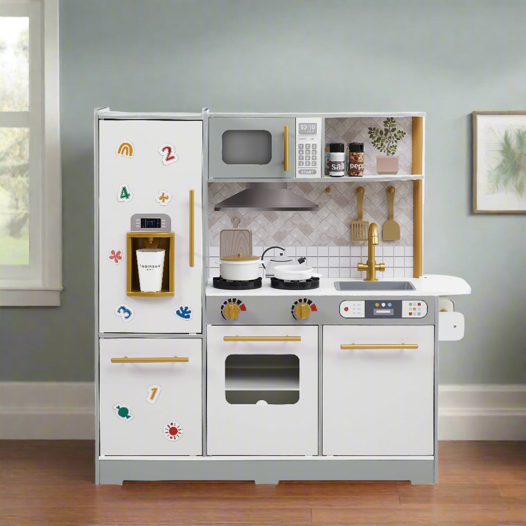 a gray kitchen with white facing cabinets is shown in a play room